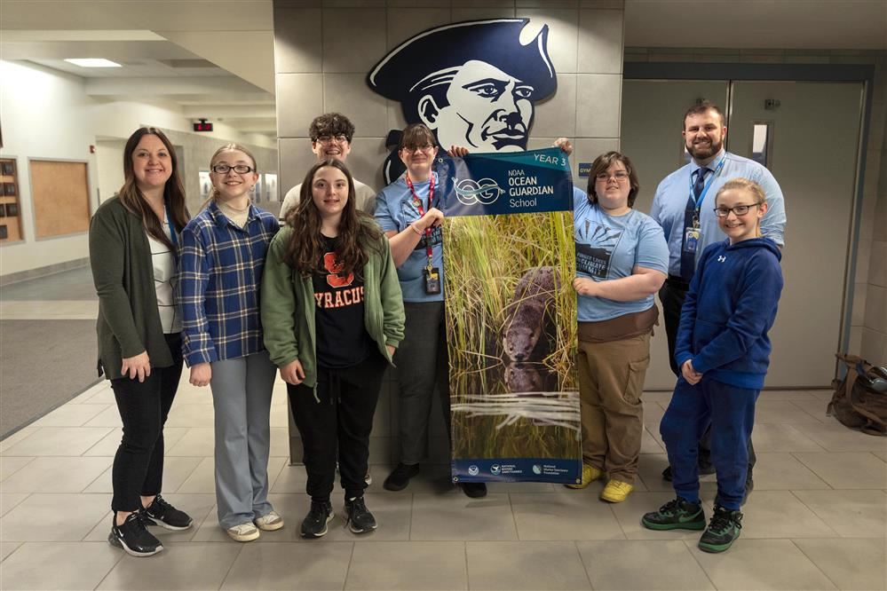  The APW Conservation Club and members of administration show off the school’s new NOAA Ocean Guardi